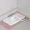 A white hands-free mop with a rotating head and reusable microfiber cloth resting on a pink towel.