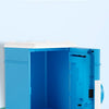 A bright blue electronic password piggy bank with an open compartment and a white lid, displayed on a light surface.