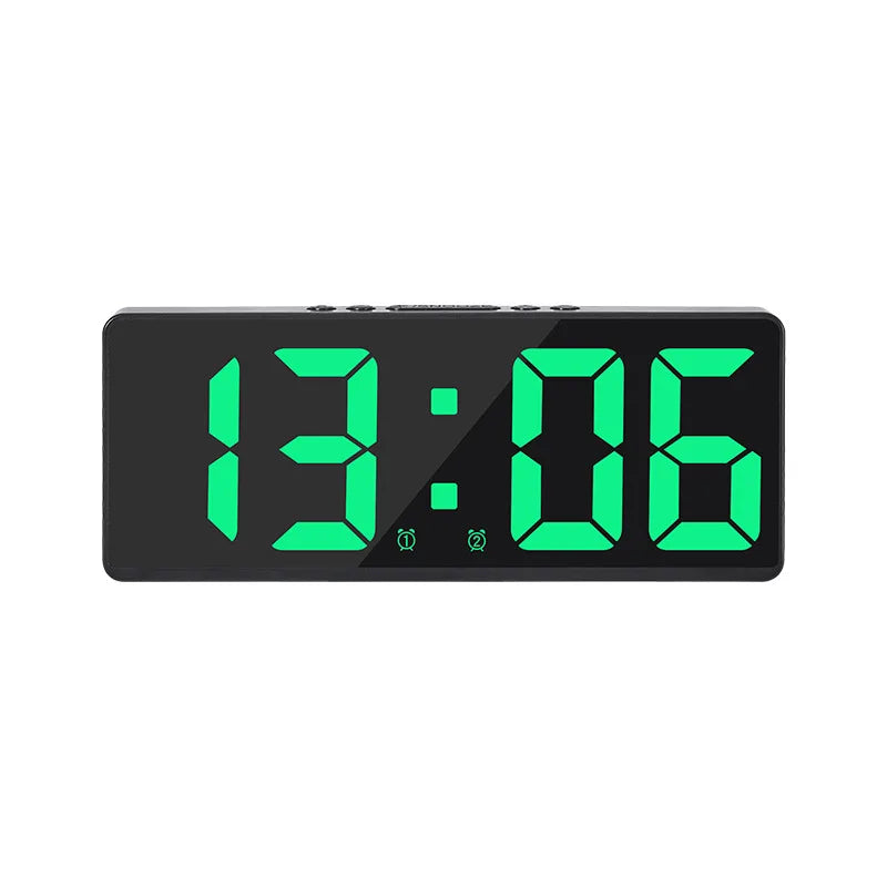 A black digital alarm clock displaying the time 13:06 with bright green LED digits.