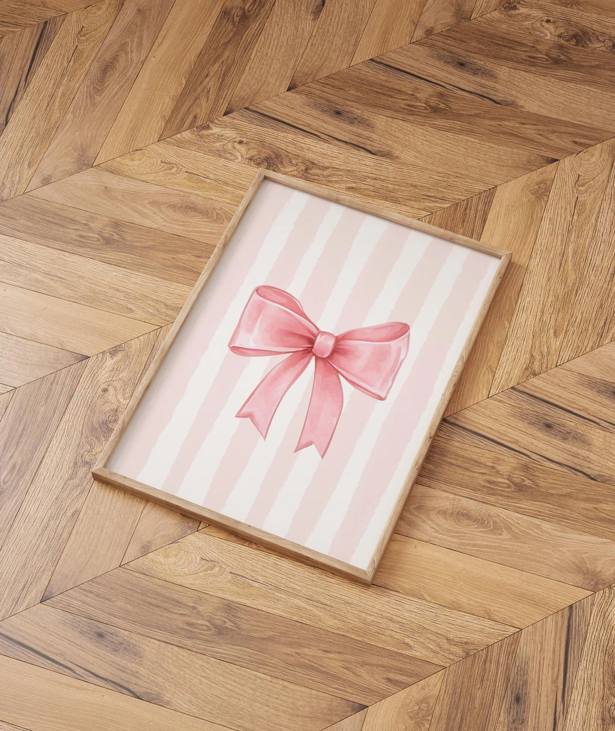 Pastel pink striped canvas wall art featuring a bow design on a wooden frame.