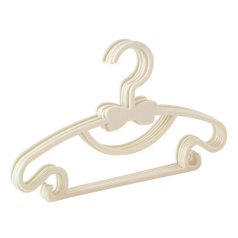 A beige plastic clothes hanger with a hook shape for hanging clothing.