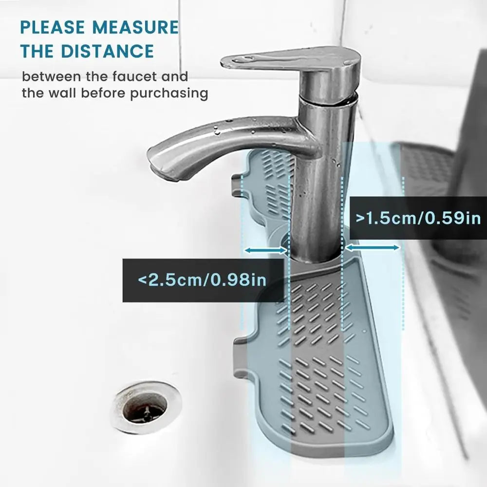 A close-up view of a flexible silicone sink splash guard drip catcher mat being measured against a wall.
