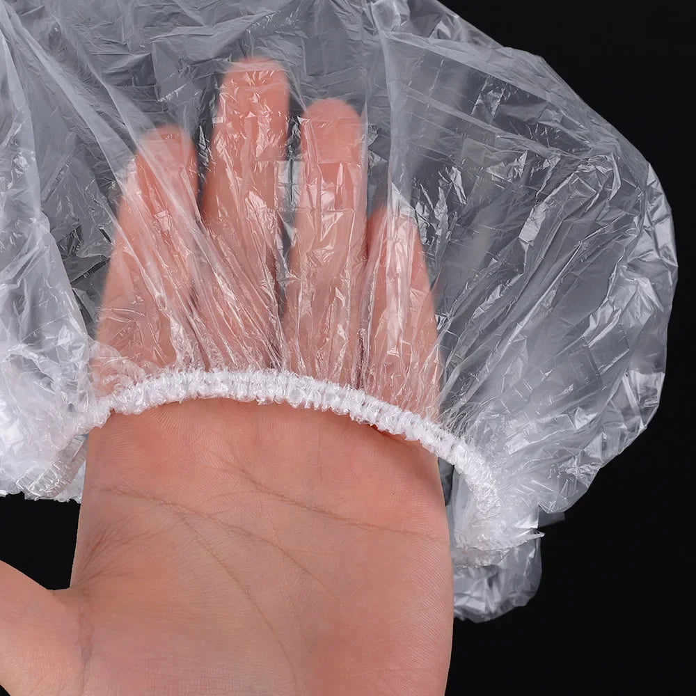 A hand is visible through a clear plastic shower cap, showing the fingers and palm.