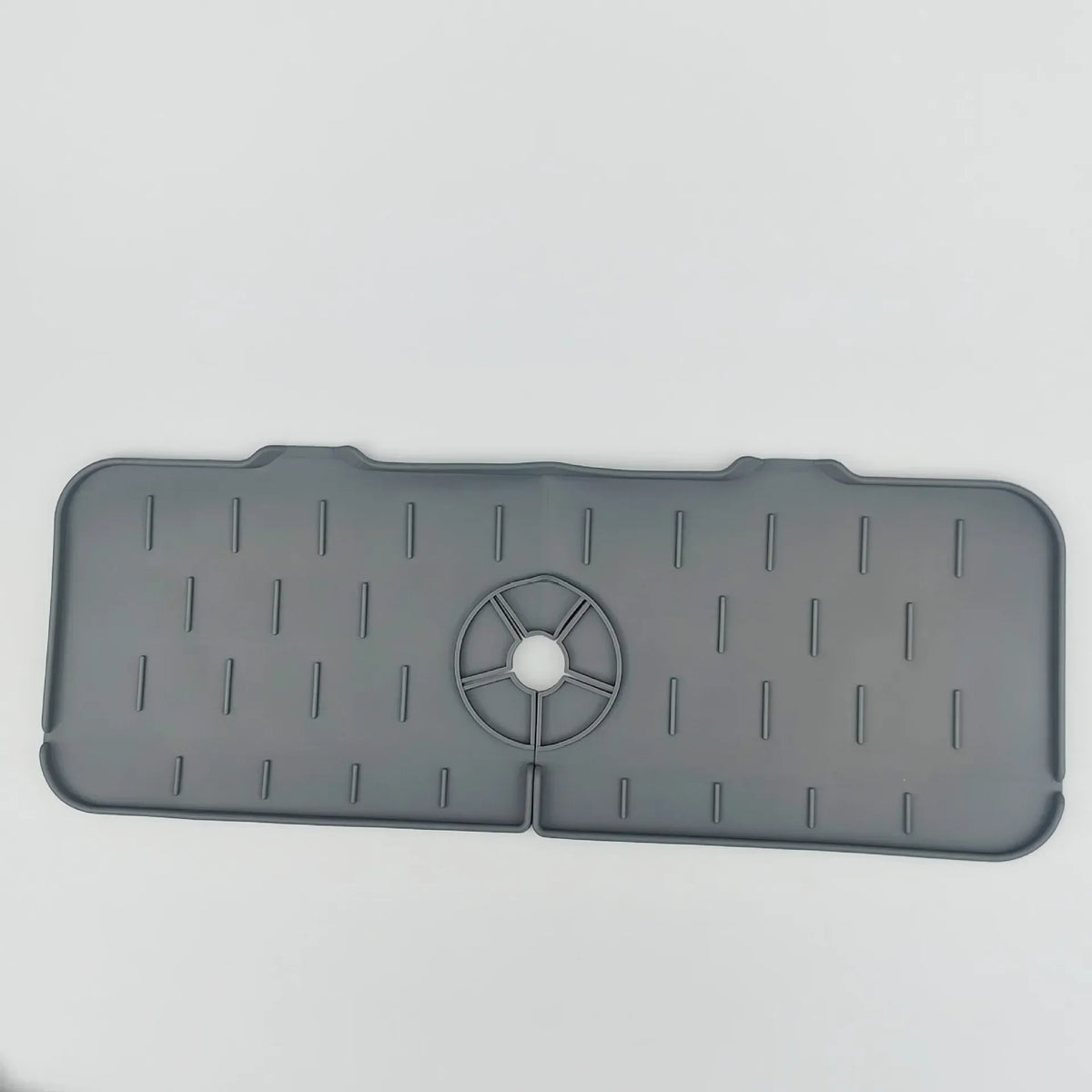 A gray silicone kitchen sink drainer and splash guard mat with multiple drainage slots.