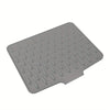 A gray silicone dish drying mat with raised drainage ridges.