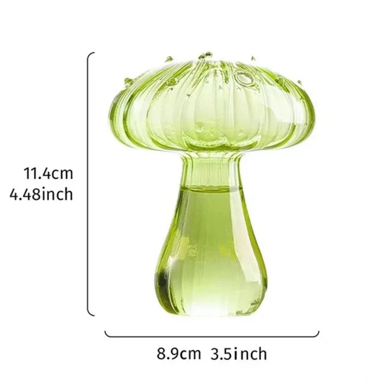 A light green glass mushroom vase with a wide cap and narrow neck, shown against a white background.