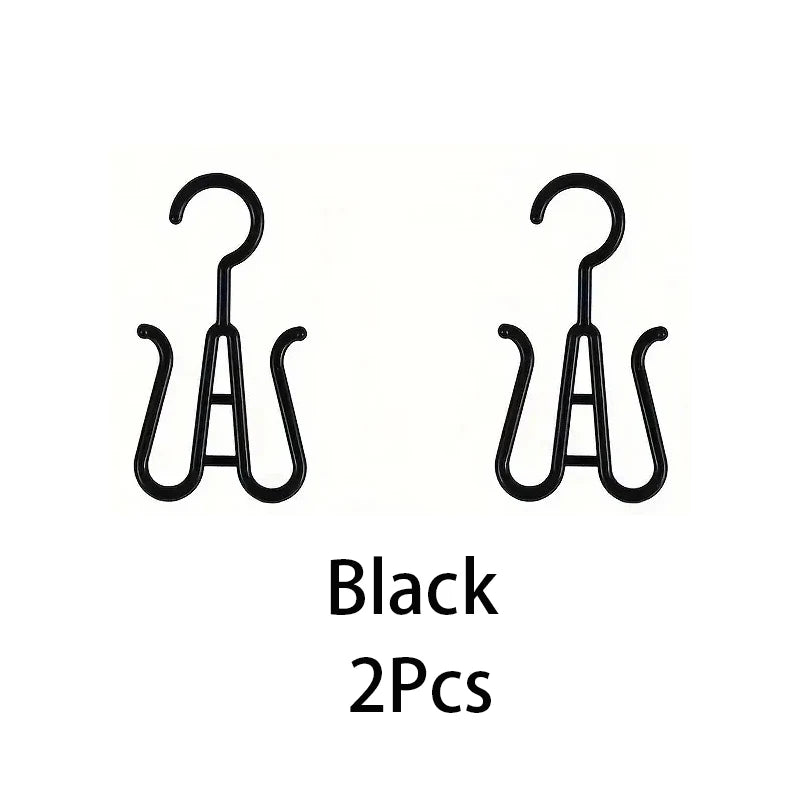 A set of two black portable plastic wig hangers.