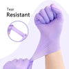 Purple disposable nitrile gloves being clenched in a fist to demonstrate tear resistance.