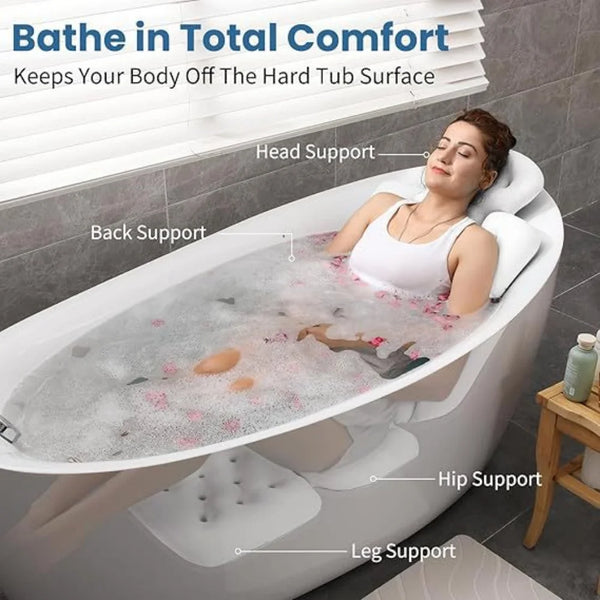 A person relaxing in a white spa bath with various supports for the head, back, hip, and legs.