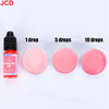 A set of cosmetic drops showing 1, 5, and 10 drops of fluorescent red liquid candle dye.