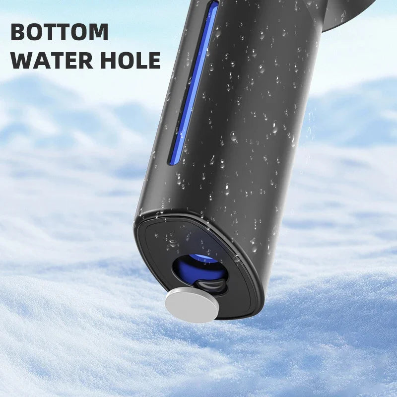 Close-up view of a portable handheld cooling fan with a bottom water hole in a snowy environment.