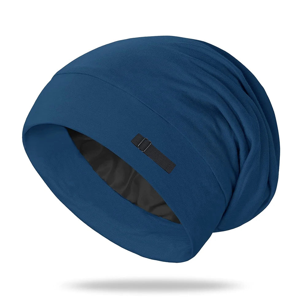 A navy blue adjustable silk-lined night cap is shown from the side.