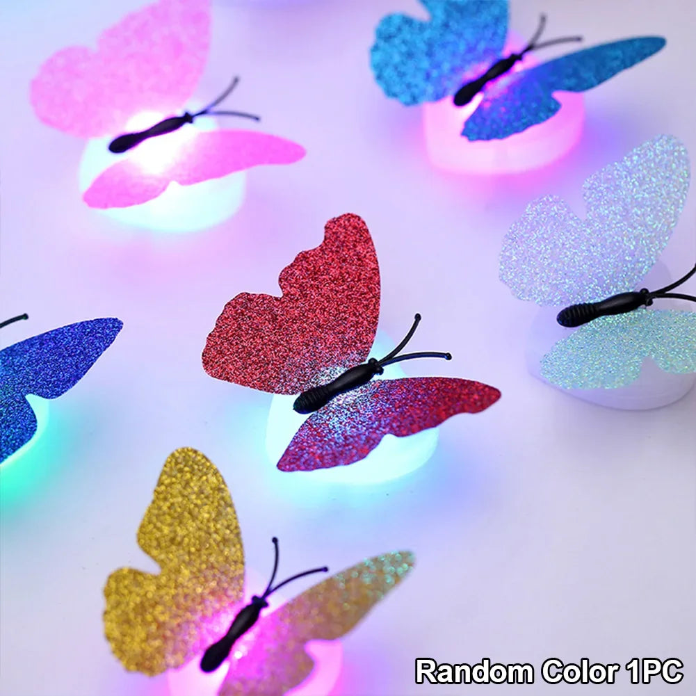 A collection of luminous 3D butterfly wall lights in various colors, including pink, blue, and red, displayed on a white surf