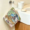 A cute Totoro cartoon-themed hanging hand wiping towel is displayed on a white bathroom counter.
