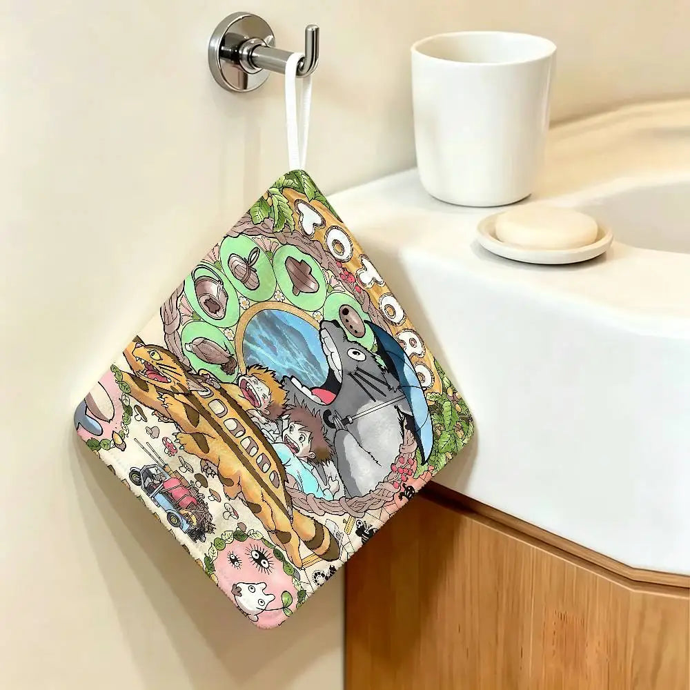 A cute Totoro cartoon-themed hanging hand wiping towel is displayed on a white bathroom counter.
