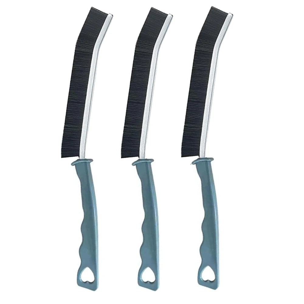 A set of three black and silver crevice cleaning brushes for tight spaces