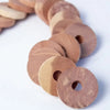 A row of natural cedar wood blocks with circular holes, used as pest deterrents.