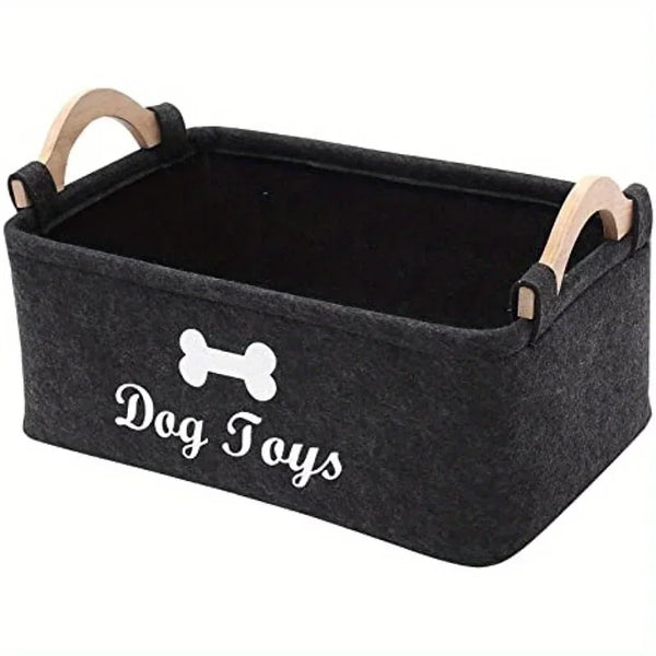 A rectangular felt storage basket with wooden handles for dog toys
