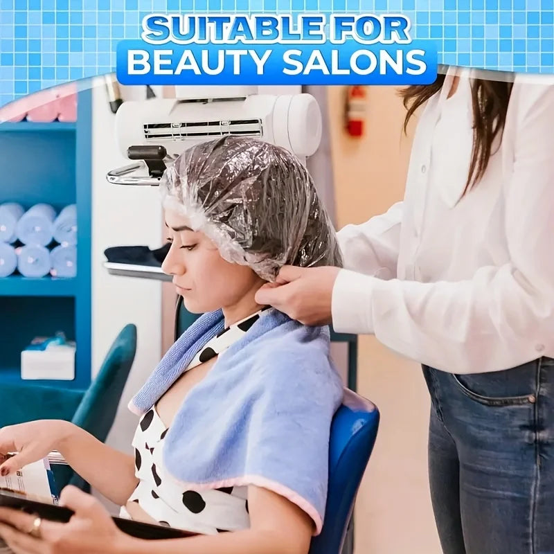 A woman is having her hair washed in a salon setting with a disposable transparent shower cap.