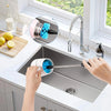 A person is cleaning a stainless steel kitchen sink using a 3-piece bottle brush set.
