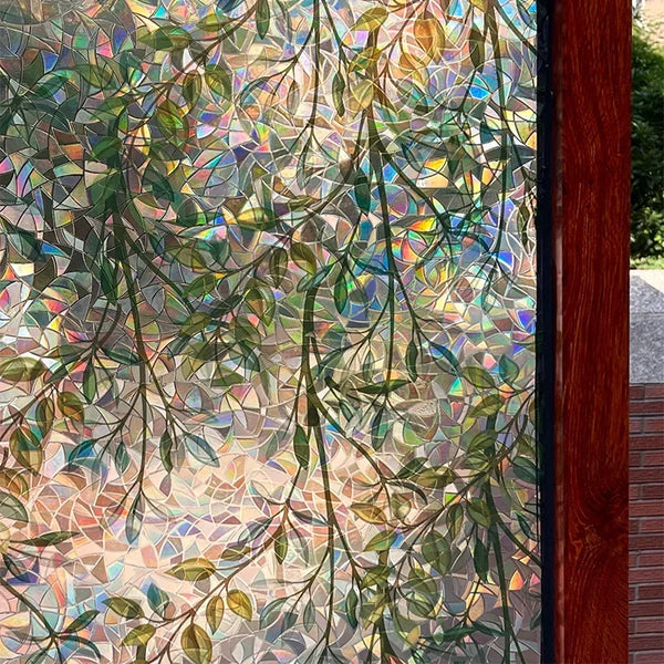 A close-up of green vines window clings featuring iridescent, mosaic-like patterns on a glass surface.
