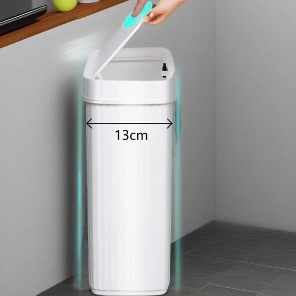 A white slim bathroom trash can with a press-fit lid is being lifted by a hand.