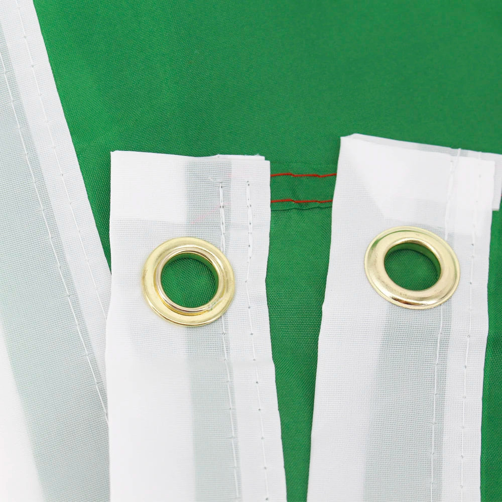 White flag decoration with gold grommets against a green background.