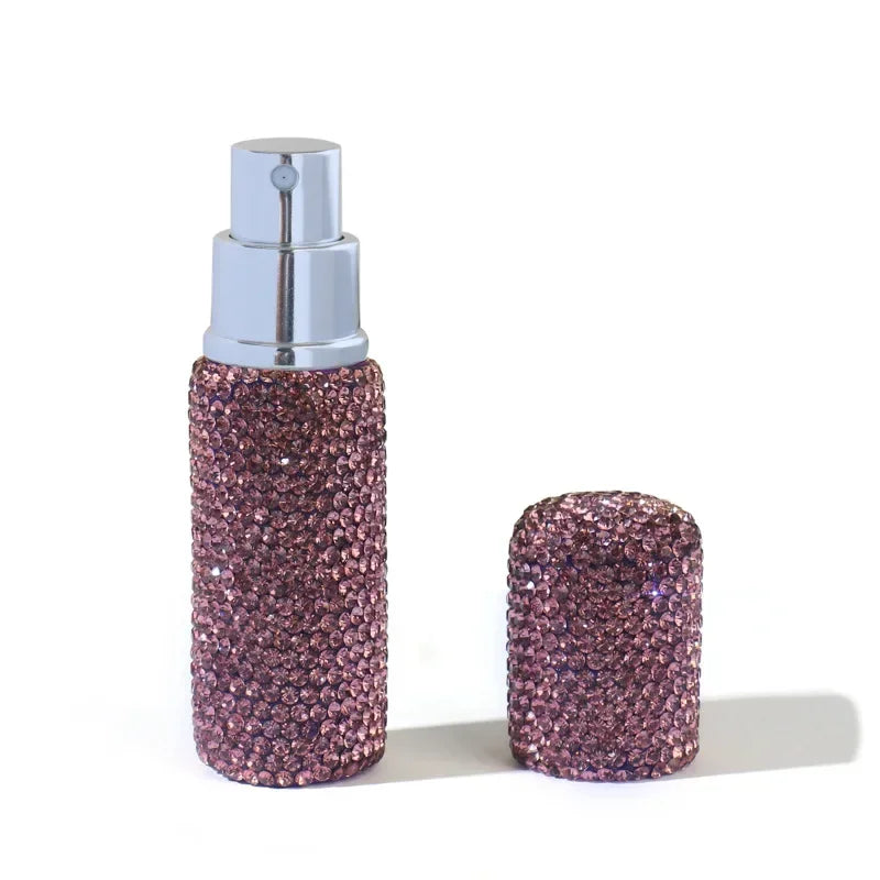 A glass perfume spray bottle with a silver cap and a textured, glittery purple body.