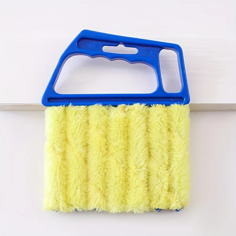 A yellow bristled cleaning brush with a blue handle is shown against a white background.