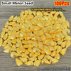A pile of small golden melon seeds used as decorative ornaments
