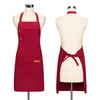 A deep red canvas apron with adjustable straps displayed on a mannequin.