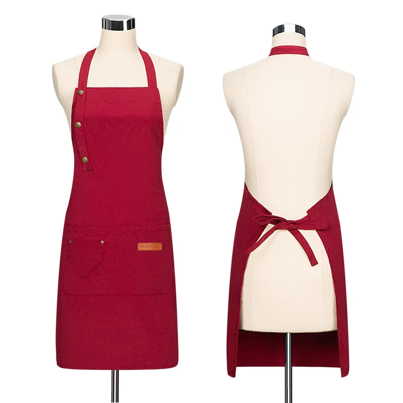 A deep red canvas apron with adjustable straps displayed on a mannequin.