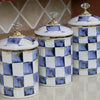 A set of retro enamel storage jars with airtight lids featuring a blue and white checkered pattern.