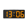 A black digital alarm clock displaying the time 13:06 with orange numerals.