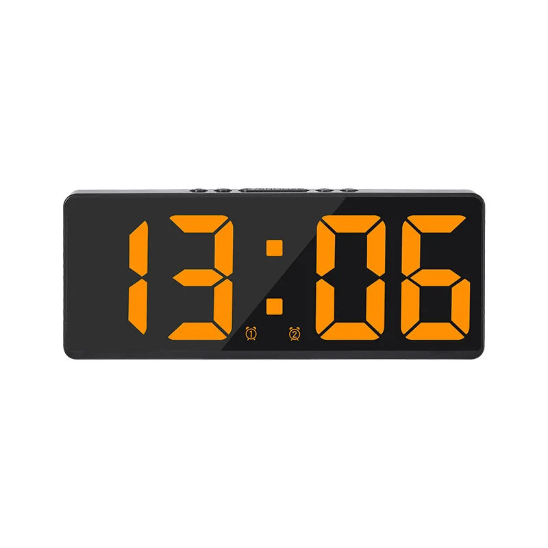 A black digital alarm clock displaying the time 13:06 with orange numerals.