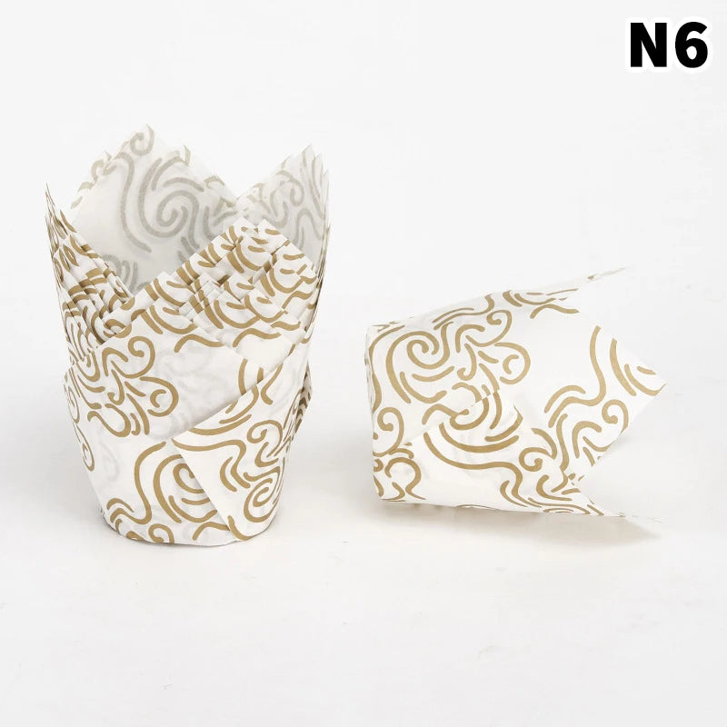 A stack of white cupcake liners featuring a gold swirling pattern for baking.