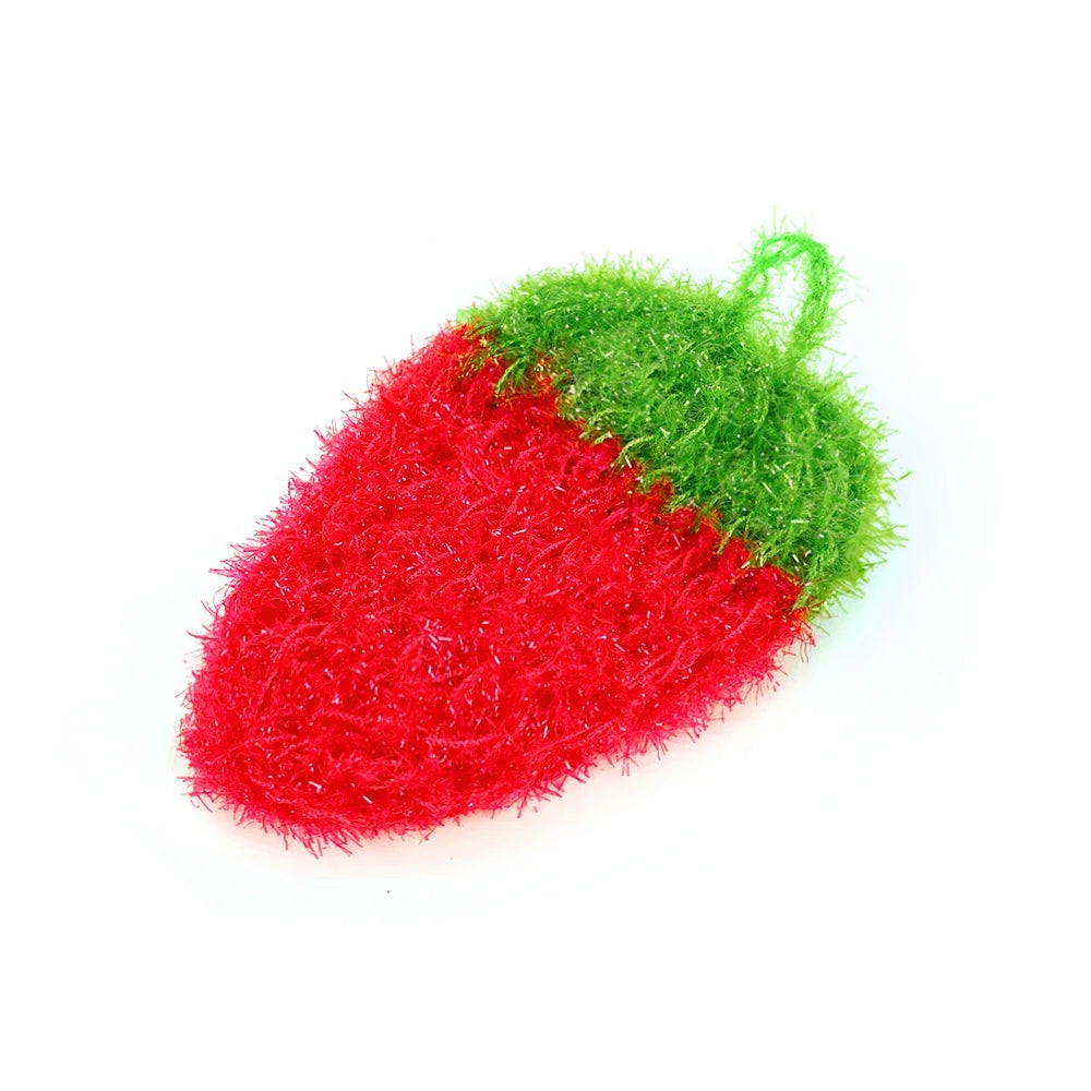 A bright red strawberry shaped sponge with green accents used for kitchen cleaning.