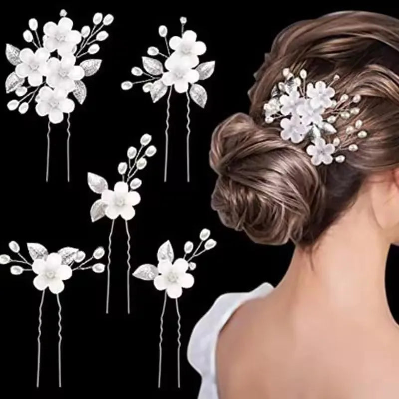 A set of white pearl flower bridal hair clips arranged in various styles for updos and hairstyles.