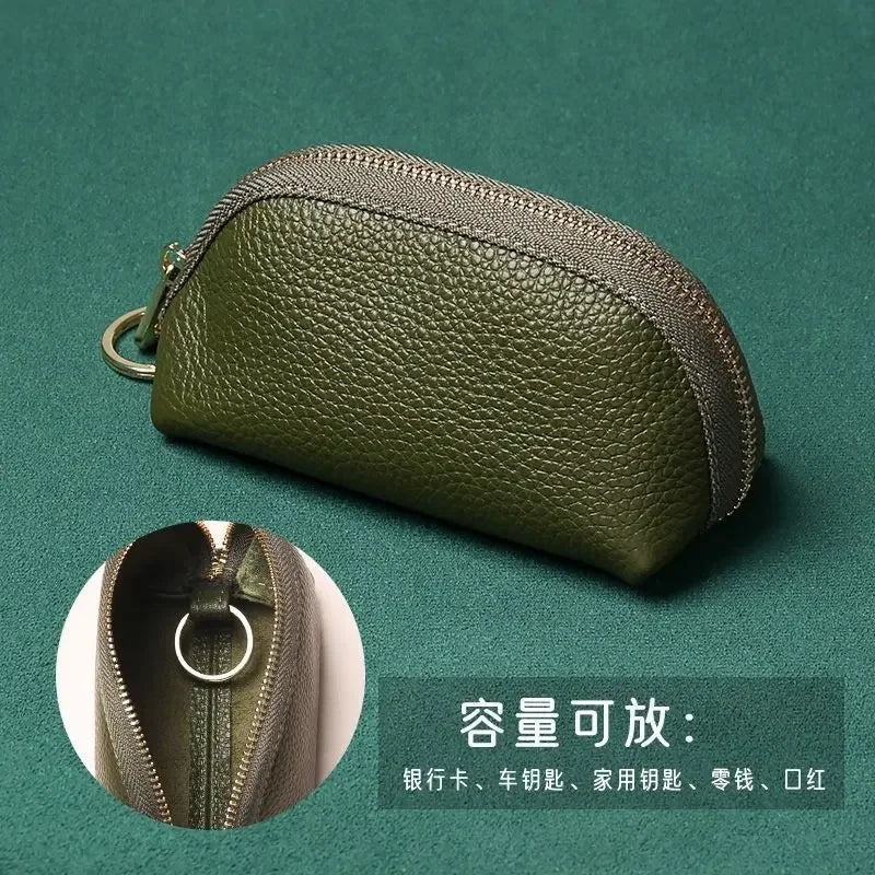Olive green leather key organizer wallet with a zipper closure shown on a dark green background.