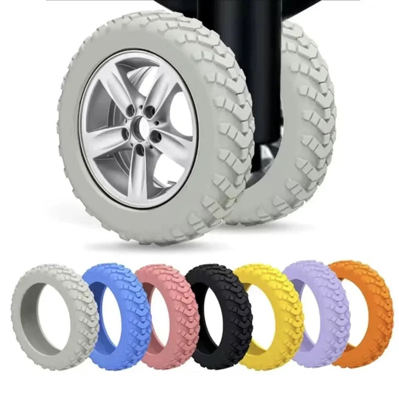 An assortment of eight colored silicone luggage wheel protectors are displayed, showing various shades including gray, blue, 