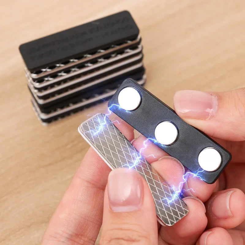 A hand holds a magnetic curtain clip with a strong adhesive backing, showing blue electrical sparks.