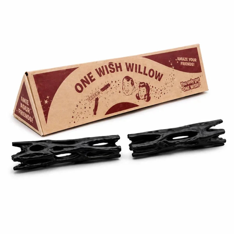 A cardboard box for a willow stick night light projector with two black wooden sticks visible.