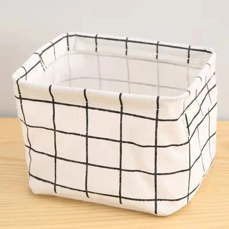 A white cotton and hemp storage basket with a black grid pattern.