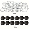 A collection of clear glass refrigerator magnets and black circular magnets are displayed.