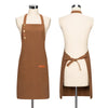 A brown canvas apron with adjustable straps displayed on a mannequin.