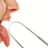 A stainless steel tongue scraper is shown next to a person's mouth.