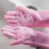 A pair of pink silicone dishwashing gloves with textured scrubbers are shown in a close-up against a white sink.