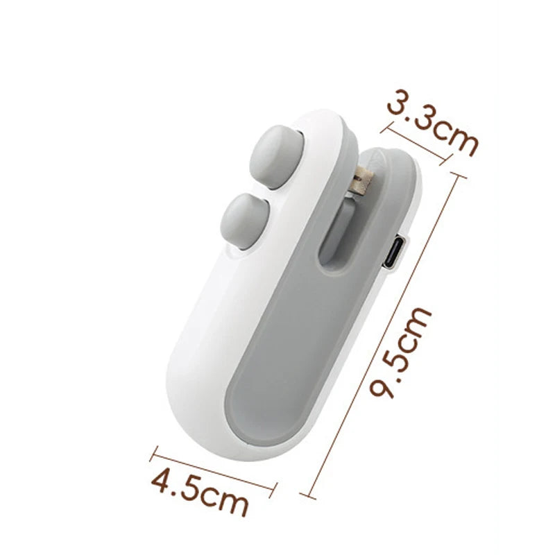 A white handheld bag sealer and cutter device shown from the side with dimensions marked.
