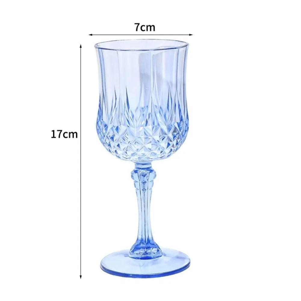 Clear blue glass champagne flute with a decorative cut pattern and stem