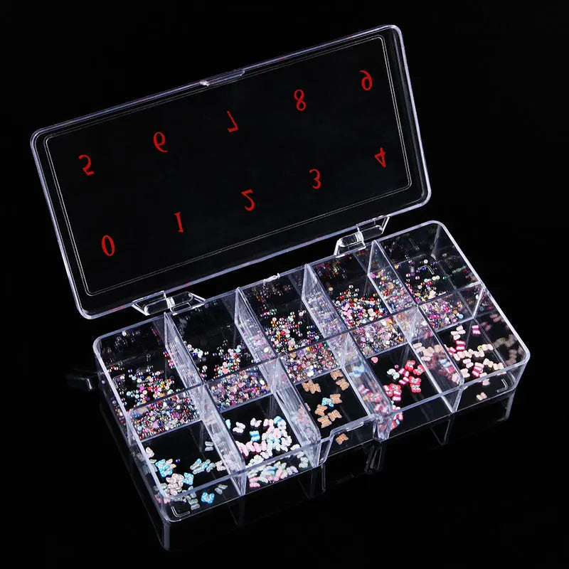 A transparent nail art organizer storage box with compartments filled with colorful glitter and nail embellishments.